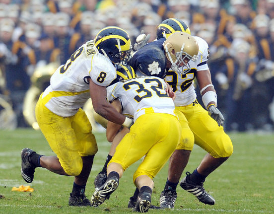 Jonas Mouton (8), Jordan Kovacs (32), and Greg Banks (92)