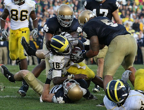Kevin Koger (86), Denard Robinson (16), and Patrick Omameh (65)