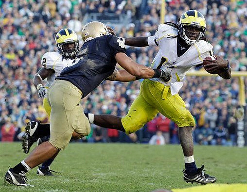 Vincent Smith (2) and Denard Robinson (16)