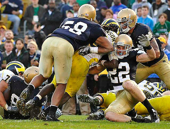 Denard Robinson (16) and Stephen Schilling (52)