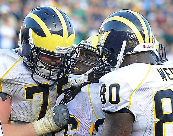 Perry Dorrestein (79), Denard Robinson (16) and Martell Webb (80)
