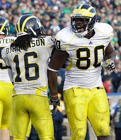 Perry Dorrestein (79), Denard Robinson (16), and Martell Webb (80)