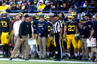 Taco Charlton (33), Jim Harbaugh, and Jordan Glasgow (23)