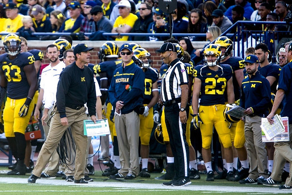 Taco Charlton (33), Jim Harbaugh, and Jordan Glasgow (23)