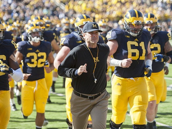 Shaun Austin (32), Jim Harbaugh, and Graham Glasgow (61)