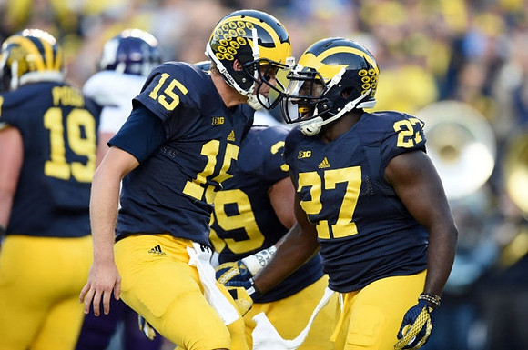 Henry Poggi (19), Jake Rudock (15), Sione Houma (39), and Derrick Green (27)