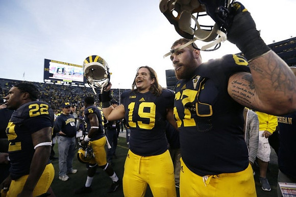 Karan Higdon (22), Jabrill Peppers (5), Henry Poggi (19), and Kyle Kalis (67)