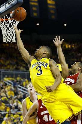 Trey Burke (3) and Blake McLimans (22)