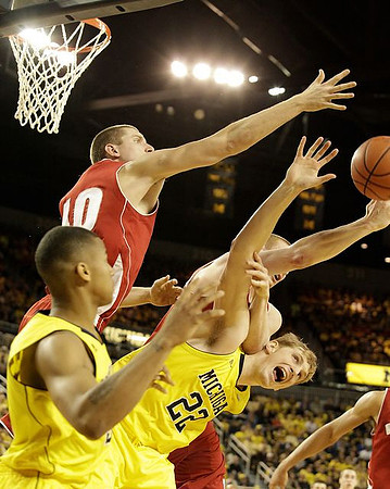 Trey Burke (3) and Blake McLimans (22)