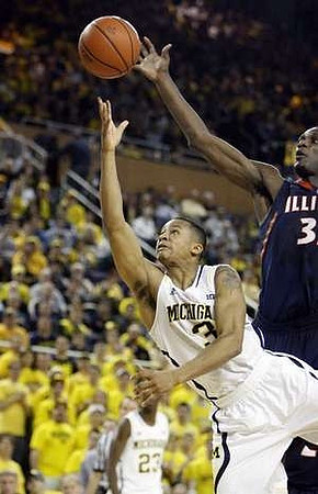 Trey Burke (3) and Caris LeVert (23)