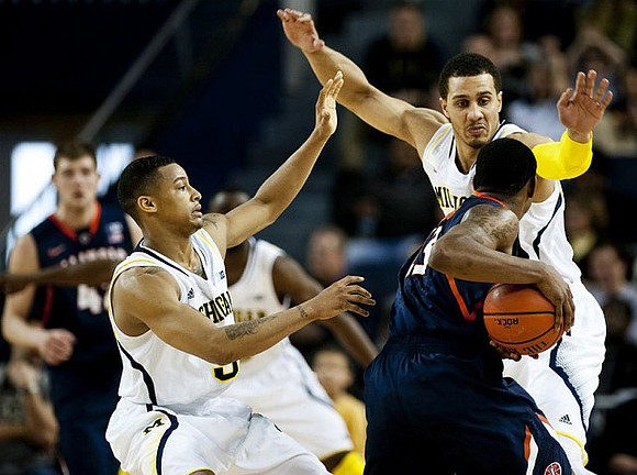 Trey Burke (3) and Jordan Morgan (52)