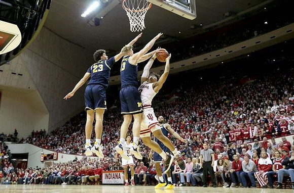 Brandon Johns Jr. (23), Ignas Brazdeikis (13), and Zavier Simpson (3)