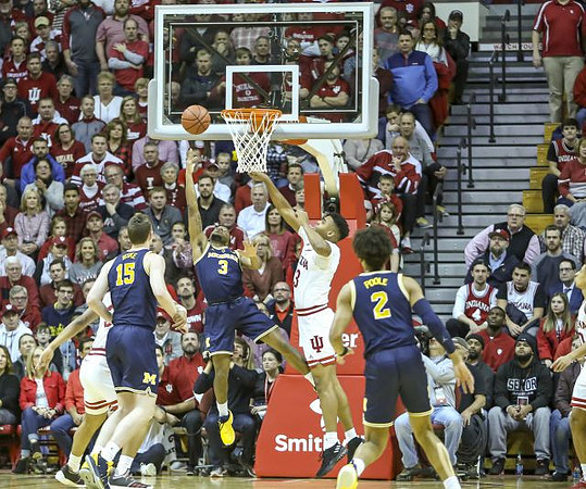 Jon Teske (15), Zavier Simpson (3), and Jordan Poole (2)
