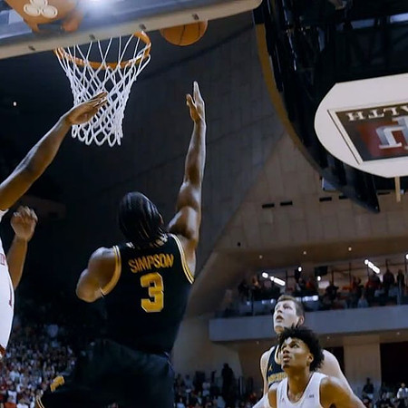 Zavier Simpson (3) and Jon Teske (15)