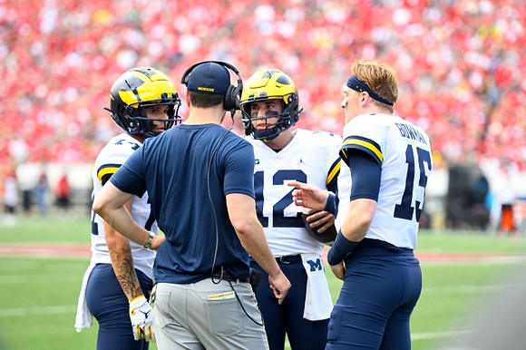 Roman Wilson (14), Cade McNamara (12), and Alan Bowman (15)