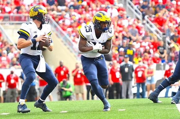Cade McNamara (12) and Hassan Haskins (25)
