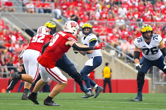 Cade McNamara (12) and Ryan Hayes (76)