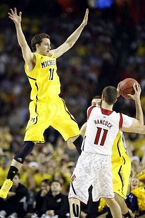 Nik Stauskas (11) and Mitch McGary (4)