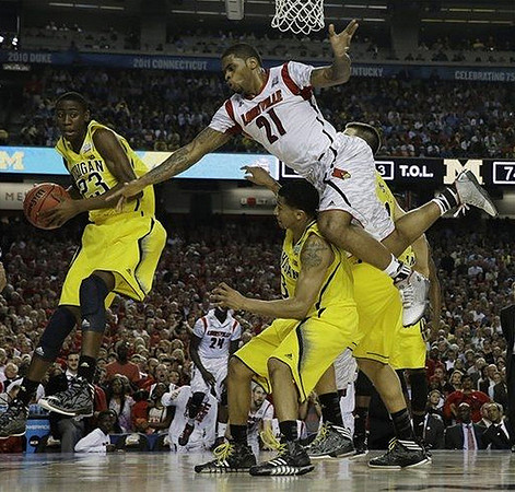 Caris LeVert (23), Trey Burke (3), and Mitch McGary (4)