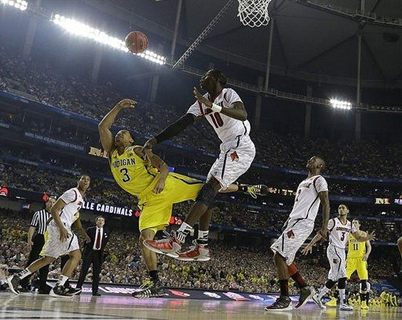Trey Burke (3), Nik Stauskas (11), and Louisville Head Coach Rick Pitino