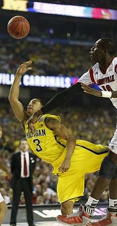 Trey Burke (3) and Louisville Head Coach Rick Pitino