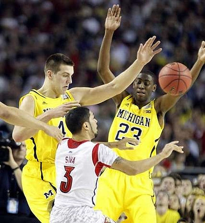 Mitch McGary (4) and Caris LeVert (23)