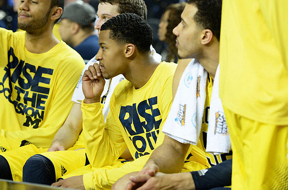 Jon Horford (15), Trey Burke (3), and Jordan Morgan (52)