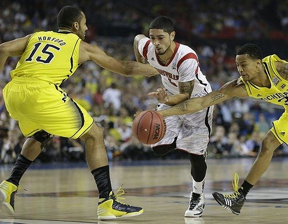 Jon Horford (15) and Trey Burke (3)