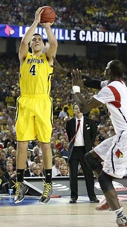 Mitch McGary (4) and Louisville Head Coach Rick Pitino