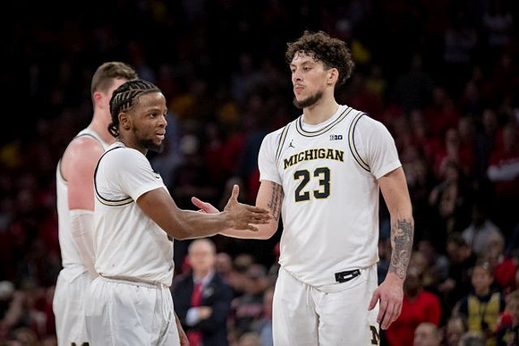 Jon Teske (15), Zavier Simpson (3), and Brandon Johns Jr. (23)