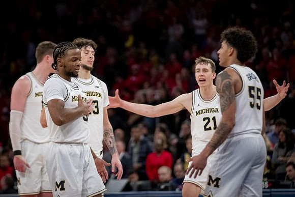 Jon Teske (15), Zavier Simpson (3), Brandon Johns Jr. (23), Franz Wagner (21), and Eli Brooks (55)