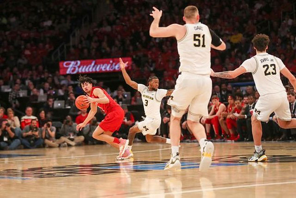 Zavier Simpson (3), Austin Davis (51), and Brandon Johns Jr. (23)