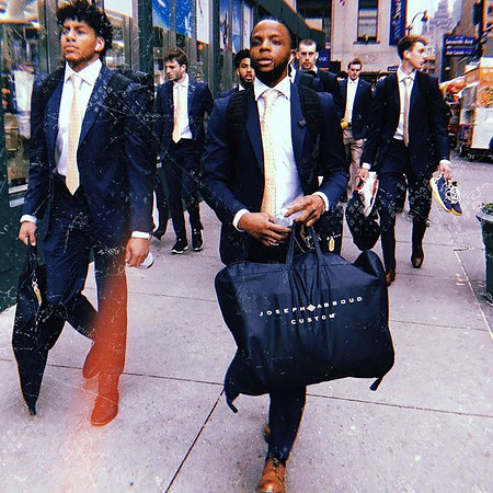 Eli Brooks (55), Zavier Simpson (3), and Michigan Team