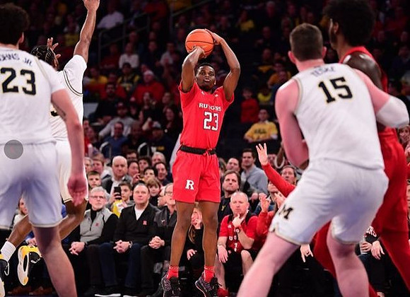 Brandon Johns Jr. (23), Zavier Simpson (3), and Jon Teske (15)