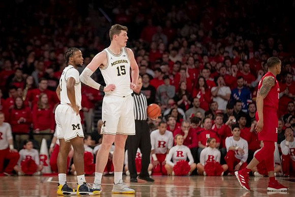 Zavier Simpson (3) and Jon Teske (15)