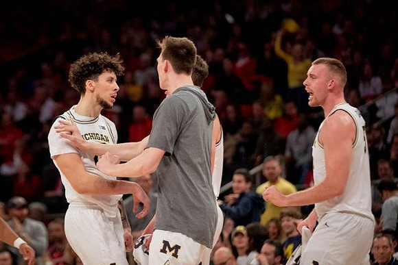 Brandon Johns Jr. (23), Colin Castleton (11), and Austin Davis (51)