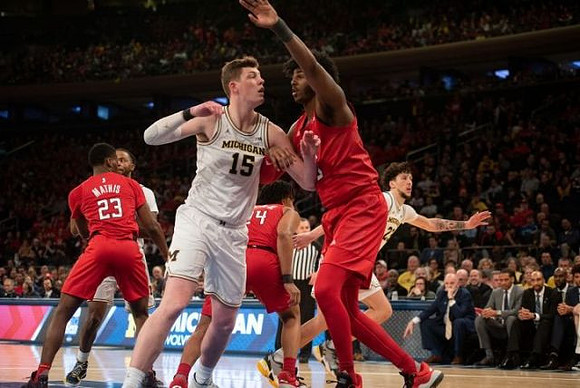 Jon Teske (15), Zavier Simpson (3), and Brandon Johns Jr. (23)
