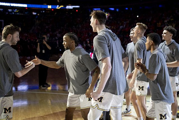 Zavier Simpson (3) and Michigan Team