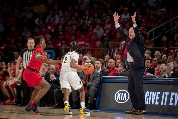 Zavier Simpson (3) and Rutgers Head Coach Steve Pikiell