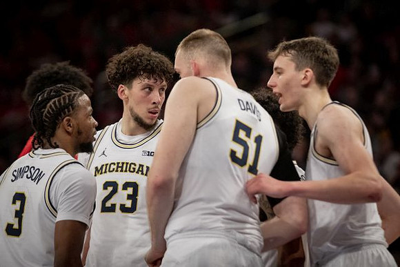 Zavier Simpson (3), Brandon Johns Jr. (23), Austin Davis (51), and Franz Wagner (21)