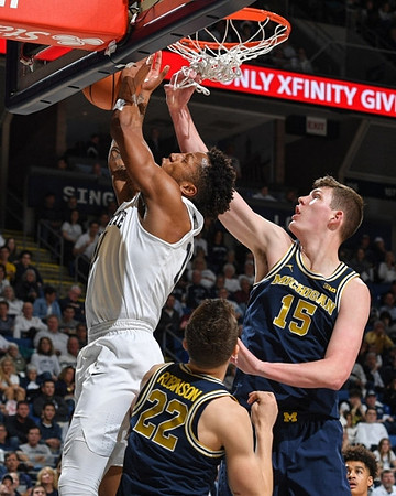 Duncan Robinson (22) and Jon Teske (15)