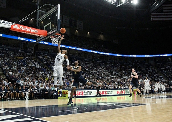 Zavier Simpson (3) and Jon Teske (15)