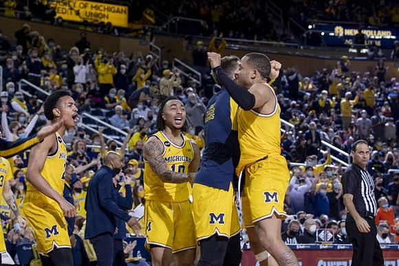 DeVante' Jones (12) and Michigan Team