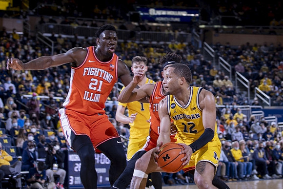 Hunter Dickinson (1) and DeVante' Jones (12)