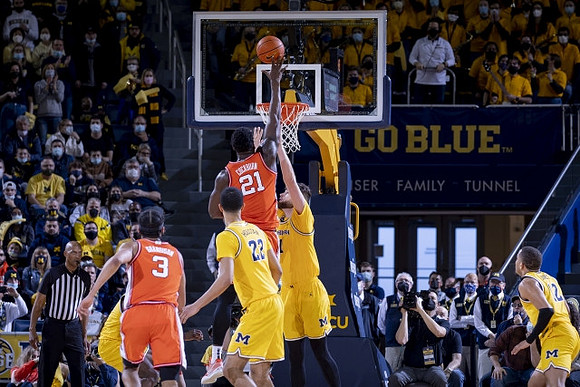 Caleb Houstan (22), Hunter Dickinson (1), and DeVante' Jones (12)