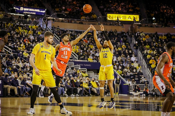 Hunter Dickinson (1) and DeVante' Jones (12)