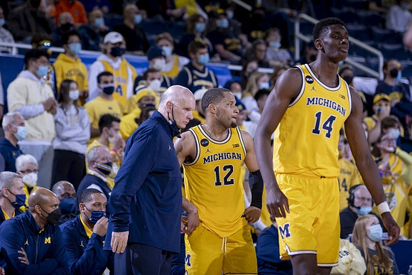 Phil Martelli, DeVante' Jones (12), and Moussa Diabate (14)