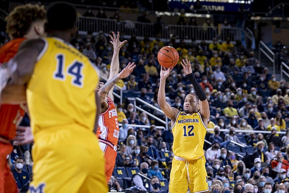 Moussa Diabate (14) and DeVante' Jones (12)