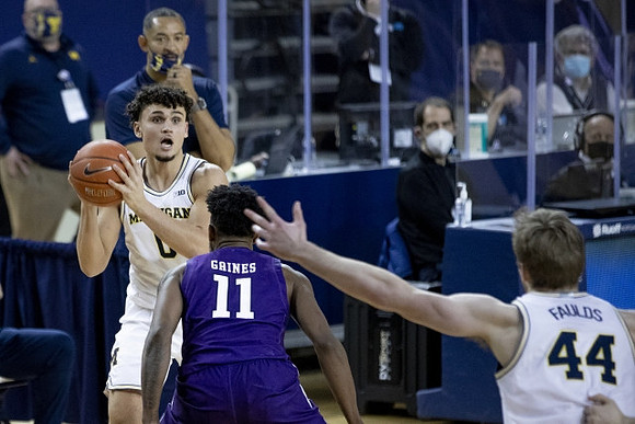 Juwan Howard, Adrien Nunez (0), and Jaron Faulds (44)