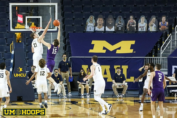 Eli Brooks (55), Mike Smith (12), Franz Wagner (21), Hunter Dickinson (1), and Chaundee Brown Jr. (15)